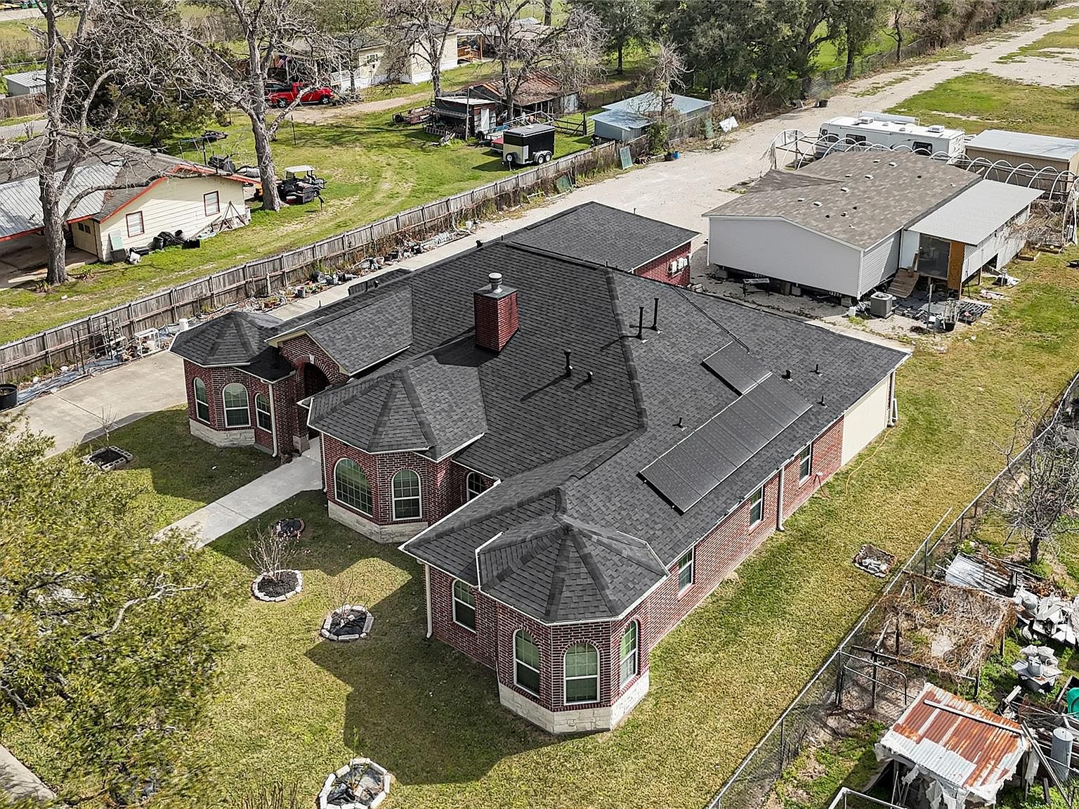 Aerial view of 6519 Breen showing the full roofline of the main house, the surrounding lot, and the second dwelling toward the back of the property